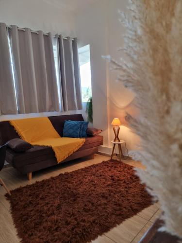 a living room with a couch and a window at Ape da Deisi Termas in Gravatal