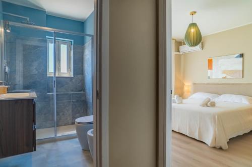 a bedroom with a bed and a bathroom with a shower at Casa Mina in Taormina