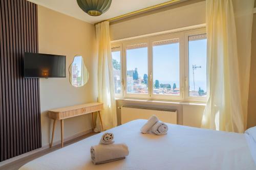 a bedroom with a bed with two towels on it at Casa Mina in Taormina