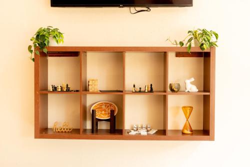 a wooden shelf on a wall with items on it at Fiesta Inn Poza Rica in Poza Rica de Hidalgo