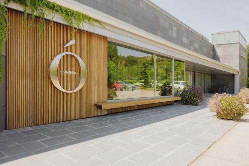 a building with a sign on the side of it at Hotel Món Sant Benet in Sant Fruitos de Bages