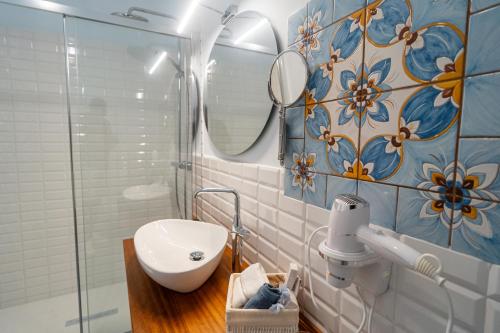 a bathroom with a sink and a mirror at Antica Loggia in Vibo Valentia