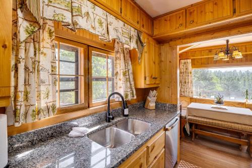 a kitchen with a sink and a window at Pike National Forest Access Secluded Divide Cabin in Divide