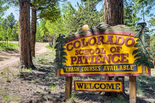 a yellow sign for a school of variance at Pike National Forest Access Secluded Divide Cabin in Divide