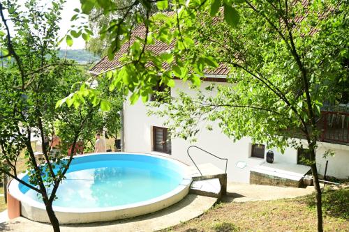 a pool in the yard of a house with trees at Tresnjin cvet in Ripanj