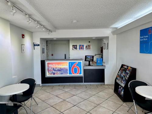 a waiting room with two tables and a large screen at Motel 6-West Monroe, LA in West Monroe