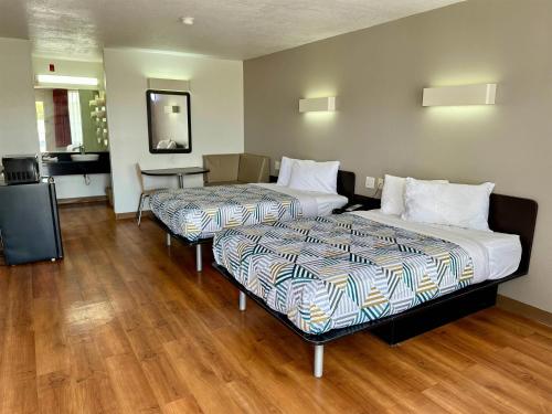 a hotel room with two beds and a kitchen at Motel 6-West Monroe, LA in West Monroe