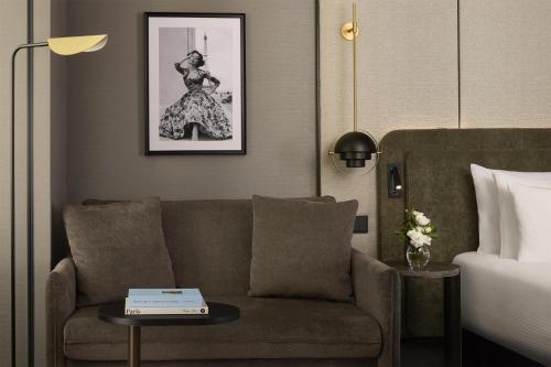 a living room with a couch and a bed at NH Collection Paris Ponthieu Champs-Élysées in Paris