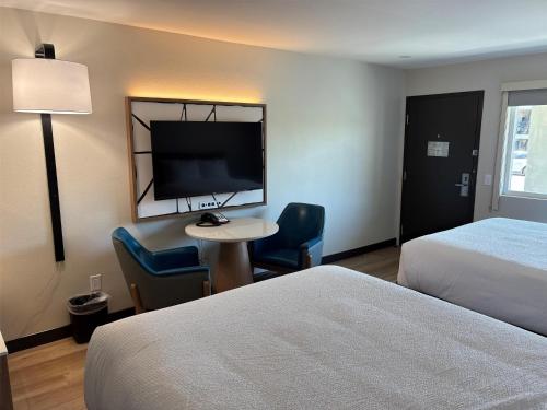 a hotel room with a bed and a desk and a tv at Best Western San Diego Pacific Beach/Mission Bay in San Diego
