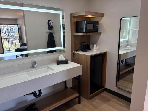 a bathroom with a sink and a mirror and a microwave at Best Western San Diego Pacific Beach/Mission Bay in San Diego