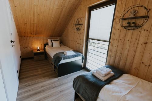 a room with two beds and a window at Słoneczne Wzgórze in Zagórze Śląskie
