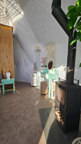 a living room with a fireplace and a table at Logements insolites du Domaine de la Tuilière in Carnoules