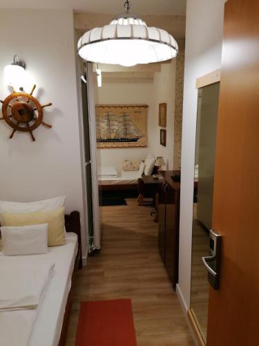 a hallway with a room with a couch and a table at Apartments 135 in Vršac