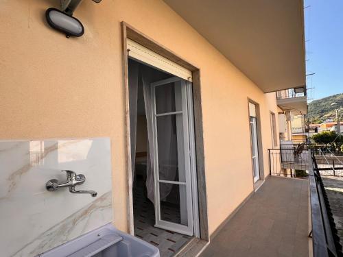 a bathroom with a sink and a door to a balcony at Nerissa in Marina di Fuscaldo
