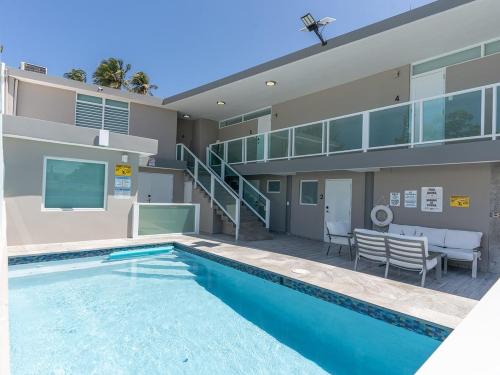 a swimming pool in front of a house at Beachfront 7 Unit Villa with Pool and Terrace 8 BD 8 Bath in Dorado