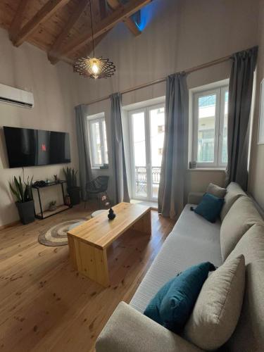a living room with a couch and a table at SITIA CITY CENTER luxury apartment in Sitia