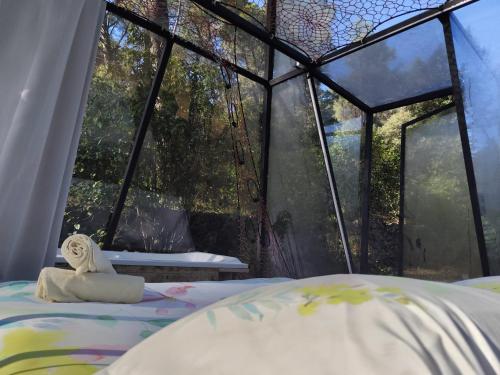 a room with a bed in front of a window at Logements insolites du Domaine de la Tuilière in Carnoules