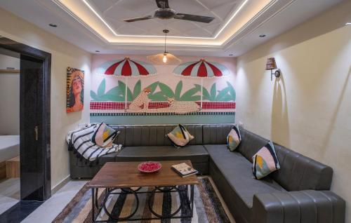 a living room with a couch and a table at Boutique Apartments By One Tree in Jodhpur