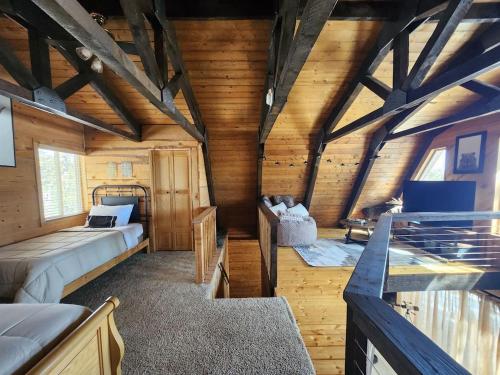 a bedroom with two beds in a wooden cabin at Rim Overlook Cabin Retreat in Duck Creek Village