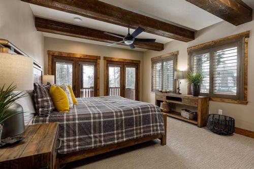 a bedroom with a bed and a couch and windows at Mossberg Luxury Retreat in Duck Creek Village