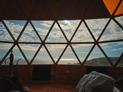 ventana grande en una habitación con vistas al océano en DomoChango, en La Serena