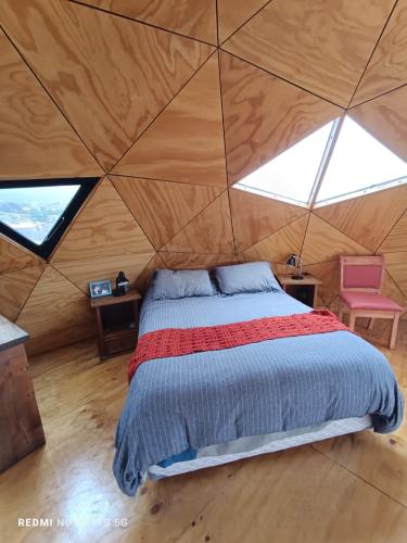 a bedroom with a bed in a tent at DomoChango in La Serena
