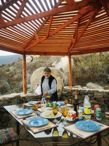 a man standing behind a table with food on it at DomoChango in La Serena