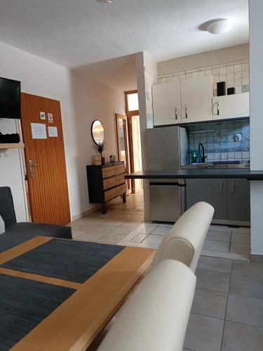 a kitchen and a living room with a table at Agava Apartments in Sutivan