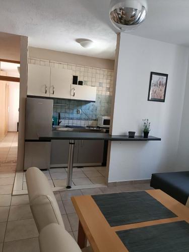 a kitchen and living room with a black counter top at Agava Apartments in Sutivan