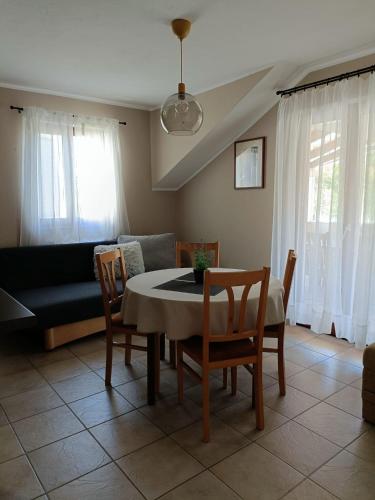 a living room with a table and chairs and a couch at Agava Apartments in Sutivan