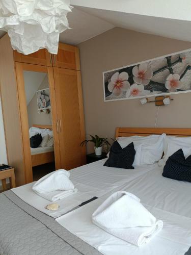 a bedroom with a bed with white towels on it at Agava Apartments in Sutivan