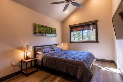 a bedroom with a bed and a ceiling fan at Good Karma Cabin - Luxury Mountain Retreat in Duck Creek Village