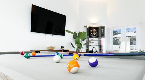 a living room with ping pong balls and a flat screen tv at 3 Bed 2 Bath A 8 Family House w Private Pool Dorado del Mar in Dorado