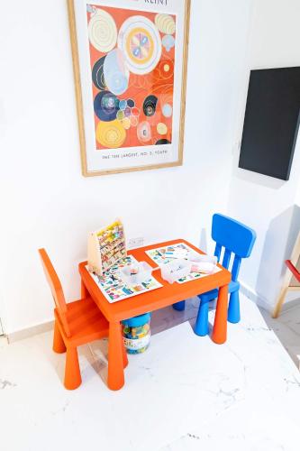 a table and two chairs and a table and a painting at 3 Bed 2 Bath A 8 Family House w Private Pool Dorado del Mar in Dorado