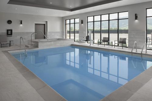 a swimming pool with blue water in a building at TownePlace Suites by Marriott Bozeman West in Bozeman