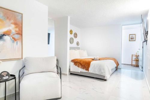 a white bedroom with a bed and a chair at 3 Bed 2 Bath A 8 Family House w Private Pool Dorado del Mar in Dorado
