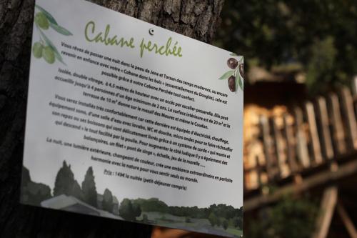 a sign is posted on a tree at Logements insolites du Domaine de la Tuilière in Carnoules