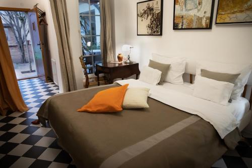 a bedroom with a large bed with white and orange pillows at Apartments 135 in Vršac