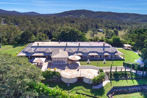 an aerial view of a large house with a yard at Amrata Estate in Samford