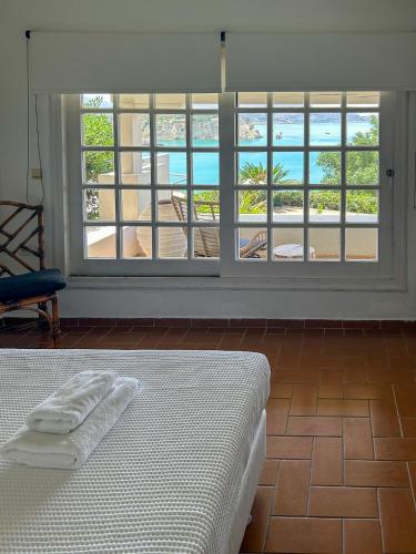 a bedroom with a bed and a view of the ocean at Studio Coconut in Almirida