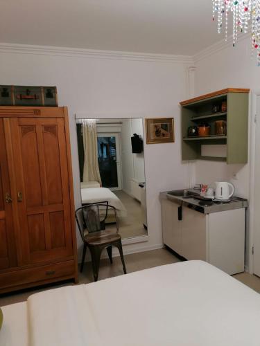 a bedroom with a bed and a kitchen with a table at Apartments 135 in Vršac