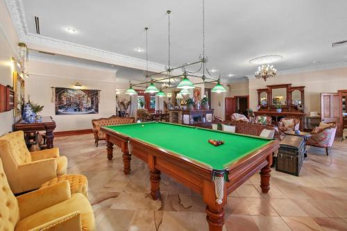 a living room with a pool table at Amrata Estate in Samford
