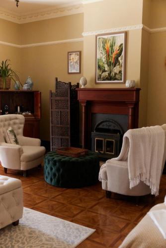 a living room with chairs and a fireplace at Amrata Estate in Samford