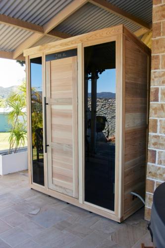 a garden room with sliding glass doors on a patio at Amrata Estate in Samford