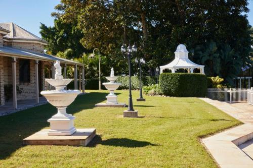 a row of white fountains in a yard at Amrata Estate in Samford