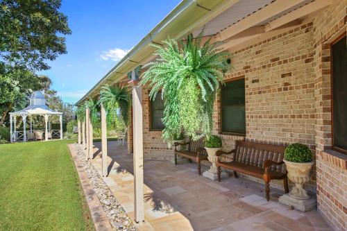a patio with two benches and a gazebo at Amrata Estate in Samford