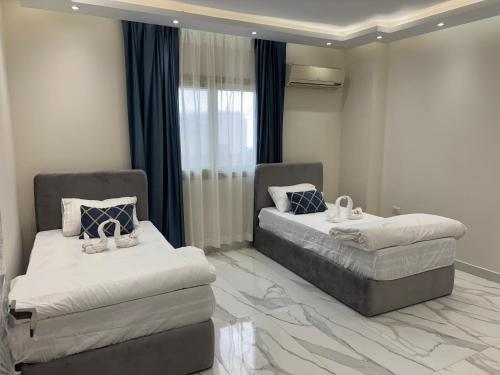 a room with two beds and a window at Zayed hotel in Sheikh Zayed