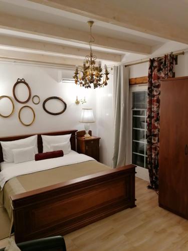 a bedroom with a large bed and a chandelier at Apartments 135 in Vršac