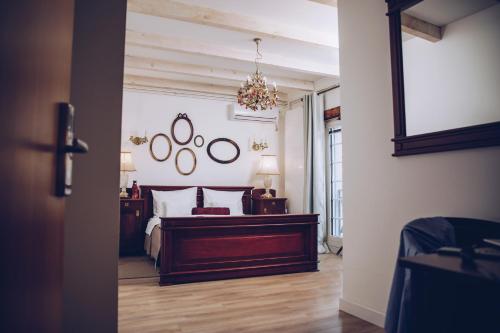 a bedroom with a bed and a mirror on the wall at Apartments 135 in Vršac
