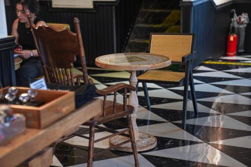 a table and two chairs sitting in a room at Chengdu Local Tea Hostel - Short Walk To Taikooli - Chill & Social Coffee Lounge - Metro downstairs - Free Activities - Friendly English Speaking Staff - Tibet, Panda, Buddha & Snow Mountain Tours in Chengdu